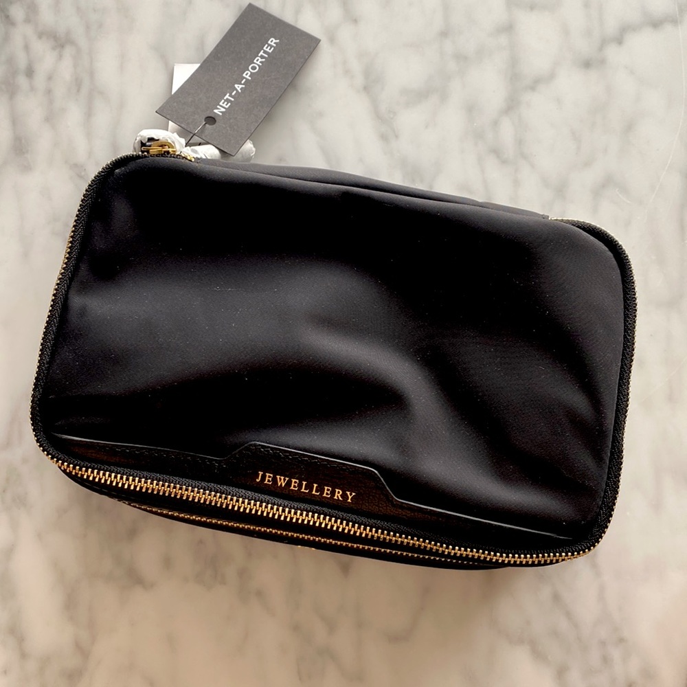 Anya Hindmarch texturwd leather-trimmed jewelry case.